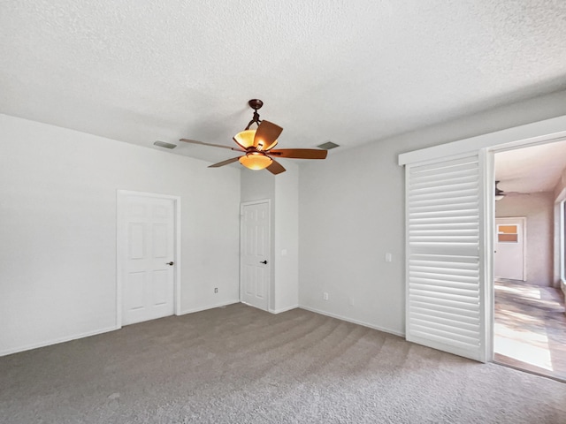 2081 SW Burlington St, Port Saint Lucie, FL 34984 - unfurnished bedroom featuring a textured ceiling, carpet floors, and ceiling fan