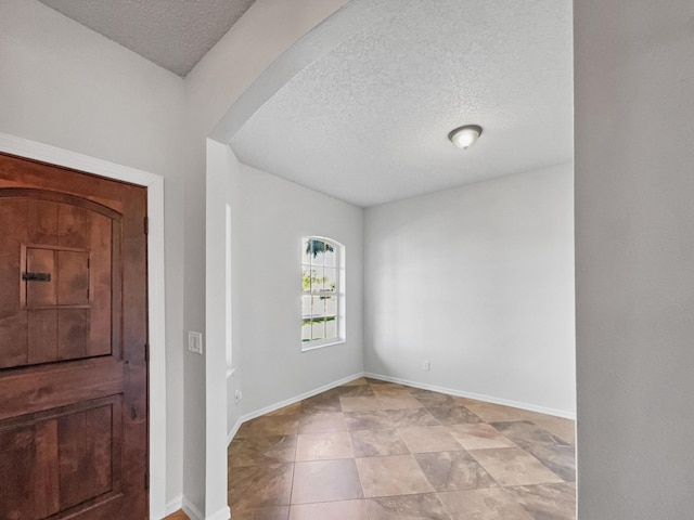 2081 SW Burlington St, Port Saint Lucie, FL 34984 - foyer entrance with a textured ceiling and arched walkways