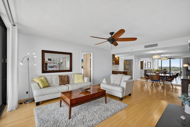 336 Golfview Rd Unit 1006, North Palm Beach, FL 33408 - living area featuring a textured ceiling, light wood-style floors, and ceiling fan