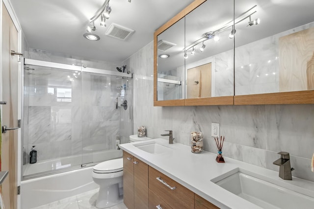 336 Golfview Rd Unit 1006, North Palm Beach, FL 33408 - bathroom featuring enclosed tub / shower combo, double vanity, and tile walls