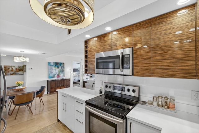 336 Golfview Rd Unit 1006, North Palm Beach, FL 33408 - kitchen with appliances with stainless steel finishes, light countertops, recessed lighting, white cabinets, and light wood-type flooring