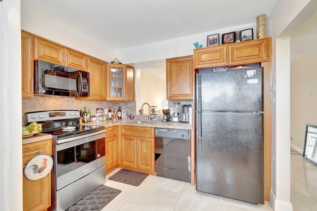 14723 Cumberland Dr Unit 404B, Delray Beach, FL 33446 - kitchen featuring black appliances, tasteful backsplash, glass insert cabinets, and light tile patterned flooring