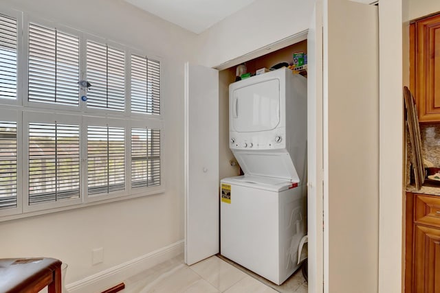 14723 Cumberland Dr Unit 404B, Delray Beach, FL 33446 - washroom featuring stacked washer / drying machine and light tile patterned floors