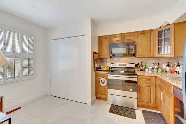 14723 Cumberland Dr Unit 404B, Delray Beach, FL 33446 - kitchen with black microwave, stainless steel range with electric cooktop, tasteful backsplash, and light stone countertops