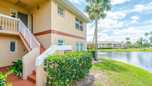 1563 SE Royal Green Cir Unit B-204, Port Saint Lucie, FL 34952 - view of property exterior featuring stucco siding, a water view, and stairway