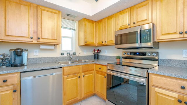1563 SE Royal Green Cir Unit B-204, Port Saint Lucie, FL 34952 - kitchen with stainless steel appliances, light tile patterned floors, light brown cabinetry, and light countertops