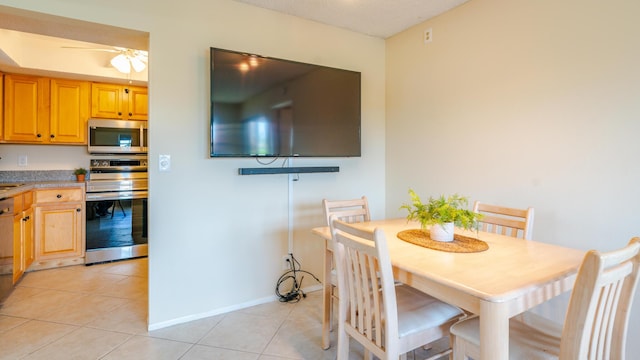 1563 SE Royal Green Cir Unit B-204, Port Saint Lucie, FL 34952 - dining space with light tile patterned floors and a ceiling fan
