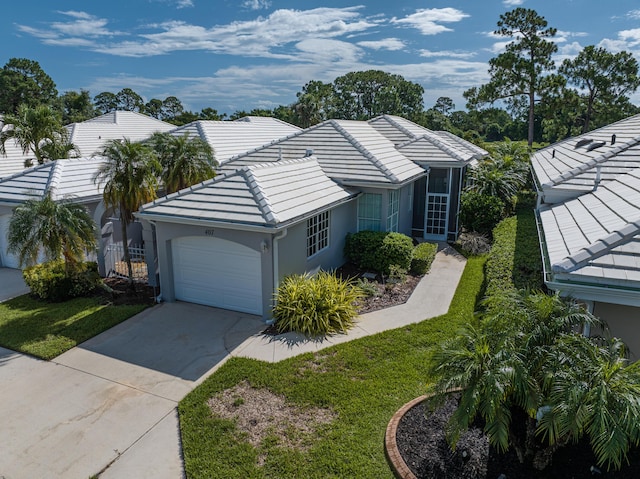 407 SW Fairway Lndg, Port Saint Lucie, FL 34986 - ranch-style home featuring stucco siding, an attached garage, a tiled roof, and driveway