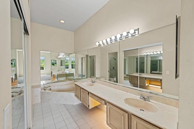 407 SW Fairway Lndg, Port Saint Lucie, FL 34986 - full bathroom with a garden tub, double vanity, a shower stall, and tile patterned floors