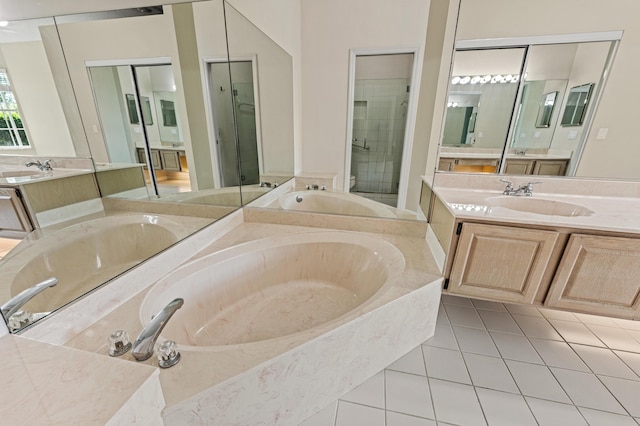 407 SW Fairway Lndg, Port Saint Lucie, FL 34986 - full bath featuring two vanities, a garden tub, tile patterned flooring, and a stall shower