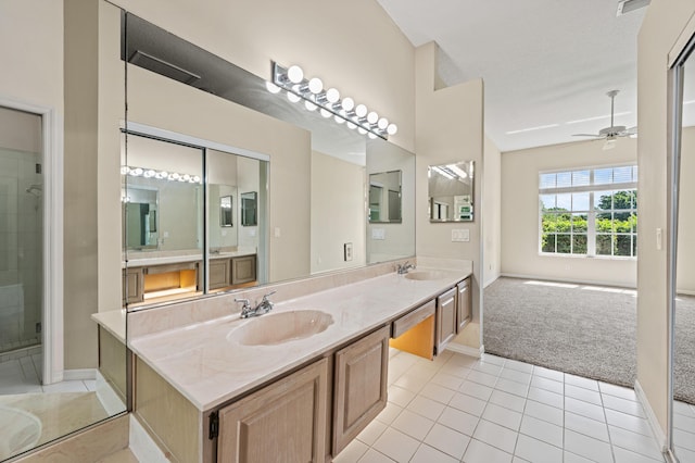 407 SW Fairway Lndg, Port Saint Lucie, FL 34986 - bathroom with double vanity, tile patterned flooring, ceiling fan, and a tile shower