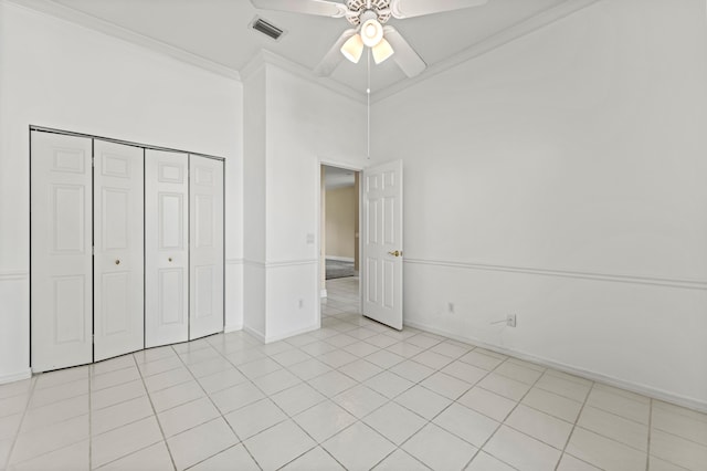 407 SW Fairway Lndg, Port Saint Lucie, FL 34986 - unfurnished bedroom featuring ornamental molding, a closet, light tile patterned floors, and ceiling fan