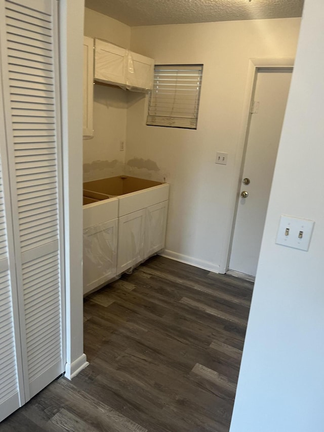 4316 Forest Rd, West Palm Beach, FL 33406 - kitchen with dark wood-style floors, white cabinets, and a textured ceiling