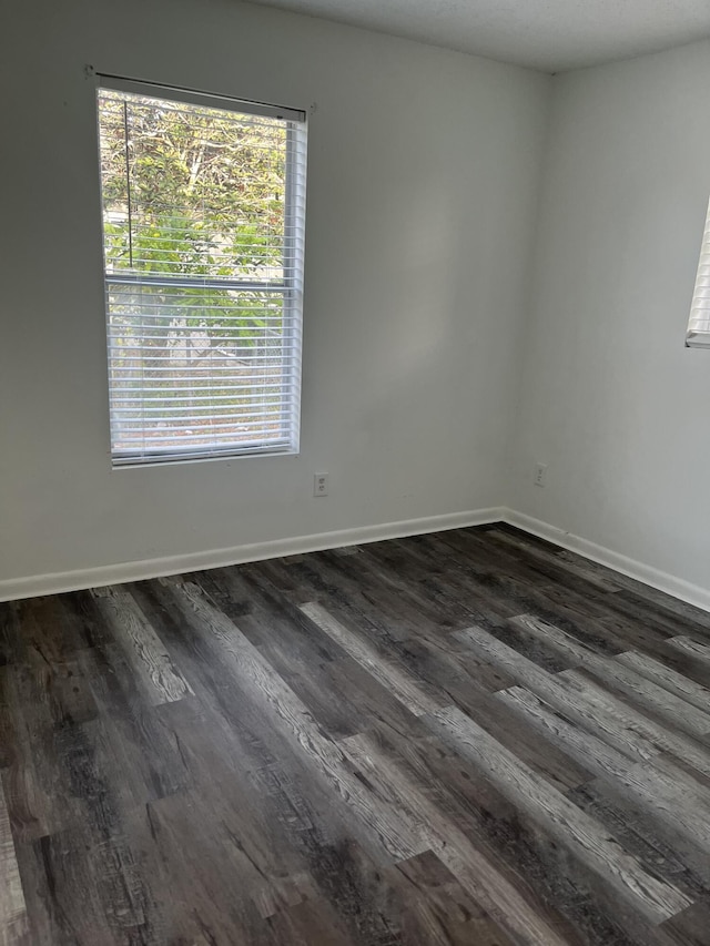 4316 Forest Rd, West Palm Beach, FL 33406 - empty room with dark wood-type flooring and healthy amount of natural light