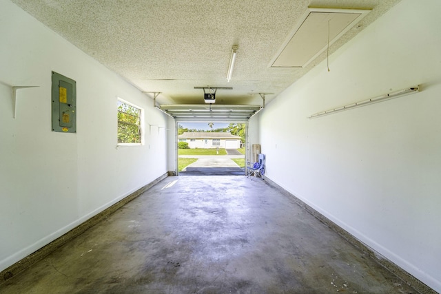 garage featuring electric panel and a garage door opener