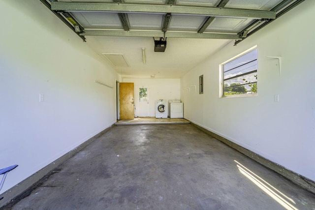 garage with washer and clothes dryer and a garage door opener