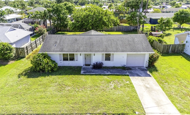 view of front facade with a garage, stucco siding, driveway, a residential view, and roof with shingles