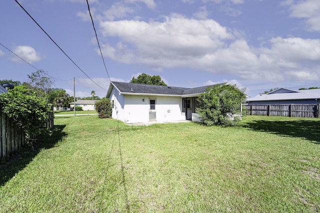 rear view of property featuring stucco siding