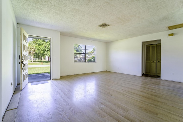 spare room with wood finished floors and a textured ceiling