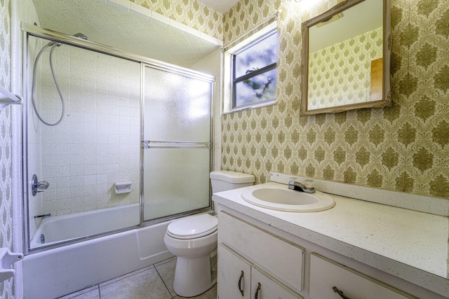 full bath with vanity, wallpapered walls, tile patterned flooring, and shower / bath combination with glass door