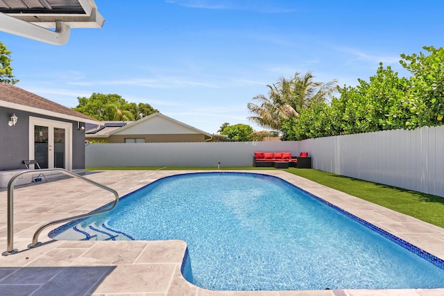 112 Parkwood Dr, Royal Palm Beach, FL 33411 - view of swimming pool featuring french doors, a fenced backyard, an outdoor living space, and a patio area