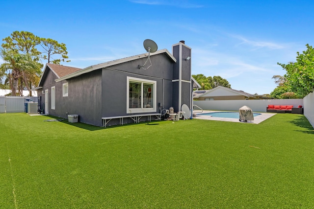 112 Parkwood Dr, Royal Palm Beach, FL 33411 - back of property with a fenced backyard and a chimney