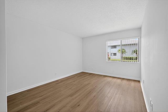 15036 Ashland Ln Unit 44, Delray Beach, FL 33484 - empty room featuring wood finished floors and a textured ceiling
