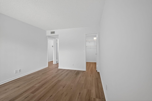 15036 Ashland Ln Unit 44, Delray Beach, FL 33484 - empty room with wood finished floors and a textured ceiling