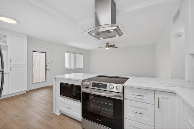 15036 Ashland Ln Unit 44, Delray Beach, FL 33484 - kitchen featuring electric range, built in microwave, island exhaust hood, white cabinets, and ceiling fan