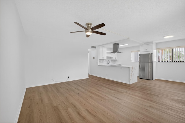 15036 Ashland Ln Unit 44, Delray Beach, FL 33484 - unfurnished living room with a ceiling fan, light wood-style floors, and a textured ceiling