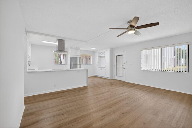 15036 Ashland Ln Unit 44, Delray Beach, FL 33484 - unfurnished living room featuring a ceiling fan and light wood finished floors