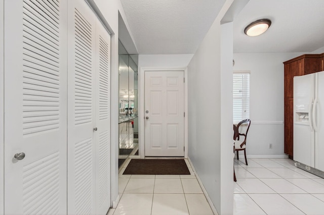 18541 Cherborg Dr Unit D, Boca Raton, FL 33496 - foyer with light tile patterned floors and baseboards