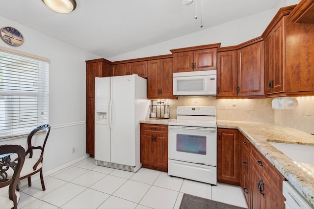 18541 Cherborg Dr Unit D, Boca Raton, FL 33496 - kitchen with white appliances, vaulted ceiling, decorative backsplash, light stone counters, and brown cabinets
