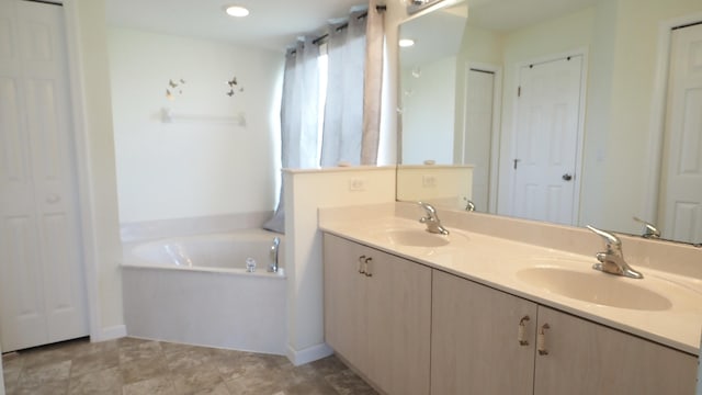 5705 NW Crocus Ave, Port Saint Lucie, FL 34986 - full bath with double vanity, a bath, and a closet
