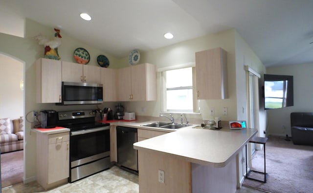 5705 NW Crocus Ave, Port Saint Lucie, FL 34986 - kitchen featuring stainless steel appliances, a peninsula, light countertops, a kitchen bar, and recessed lighting