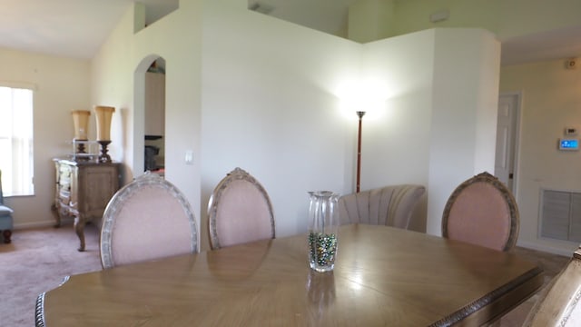 5705 NW Crocus Ave, Port Saint Lucie, FL 34986 - carpeted dining space featuring arched walkways and baseboards