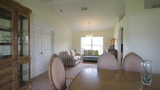 5705 NW Crocus Ave, Port Saint Lucie, FL 34986 - dining area featuring carpet floors, vaulted ceiling, and arched walkways