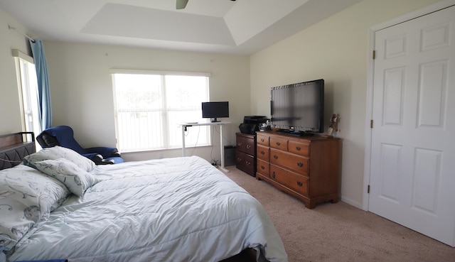 5705 NW Crocus Ave, Port Saint Lucie, FL 34986 - bedroom featuring a raised ceiling, light carpet, and ceiling fan