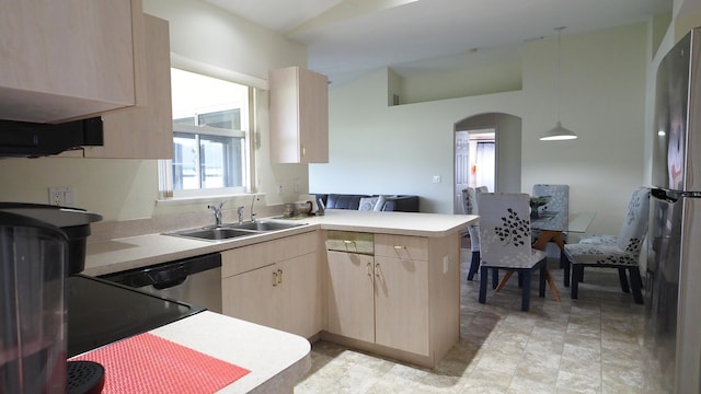 5705 NW Crocus Ave, Port Saint Lucie, FL 34986 - kitchen with light brown cabinetry, a peninsula, stainless steel appliances, arched walkways, and light countertops