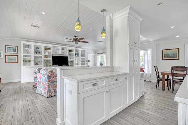 219 Claremont Ln, Palm Beach Shores, FL 33404 - kitchen featuring white cabinets, ceiling fan, recessed lighting, light wood-style floors, and pendant lighting