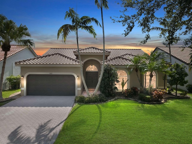 5412 NW 57th Way, Coral Springs, FL 33067 - mediterranean / spanish home with stucco siding, an attached garage, and a front yard