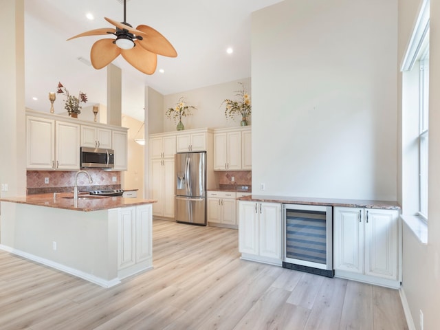 5412 NW 57th Way, Coral Springs, FL 33067 - kitchen featuring beverage cooler, appliances with stainless steel finishes, backsplash, a high ceiling, and a peninsula
