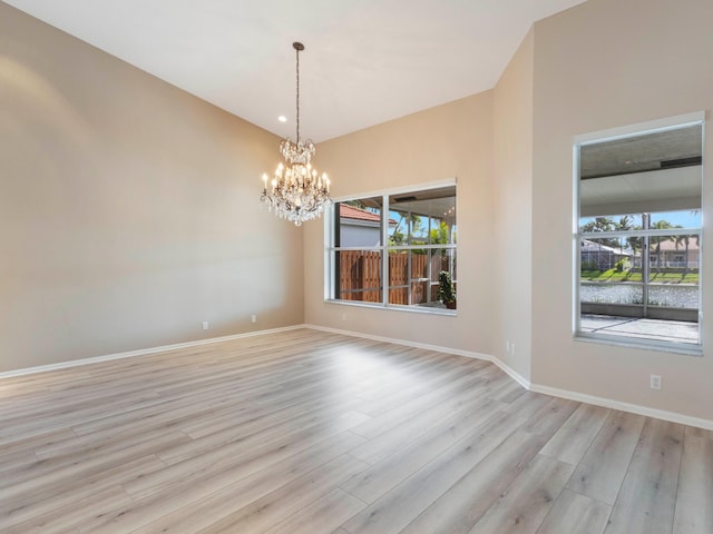 5412 NW 57th Way, Coral Springs, FL 33067 - spare room with light wood-type flooring and a chandelier