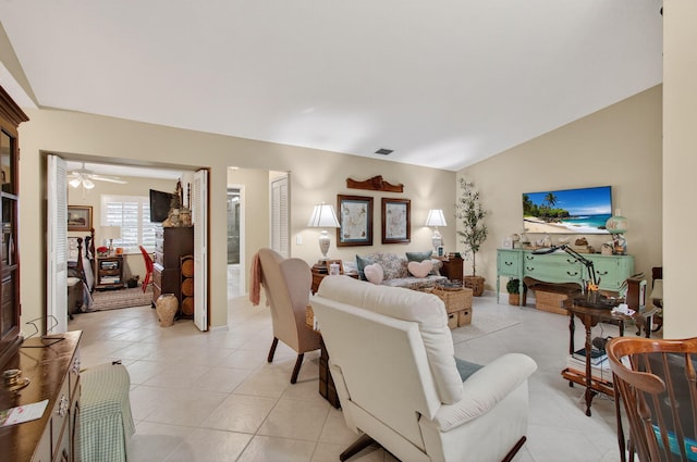 5707 Parkwalk Cir E, Boynton Beach, FL 33472 - living area featuring light tile patterned floors, vaulted ceiling, and a ceiling fan
