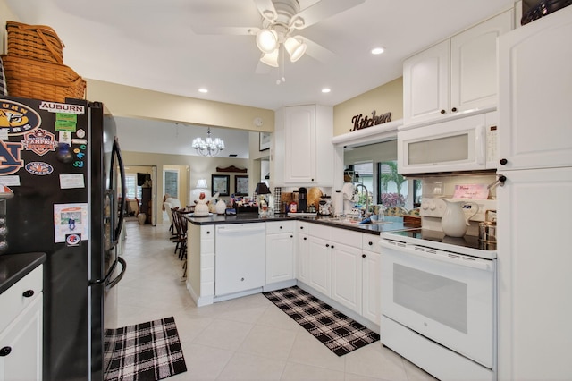 5707 Parkwalk Cir E, Boynton Beach, FL 33472 - kitchen featuring white appliances, dark countertops, ceiling fan, white cabinets, and recessed lighting