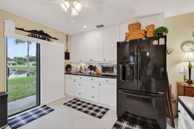 5707 Parkwalk Cir E, Boynton Beach, FL 33472 - kitchen featuring black fridge with ice dispenser, dark countertops, a ceiling fan, white cabinets, and light tile patterned floors