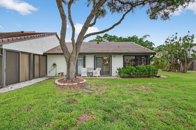 5707 Parkwalk Cir E, Boynton Beach, FL 33472 - rear view of property with a yard, a tiled roof, and stucco siding