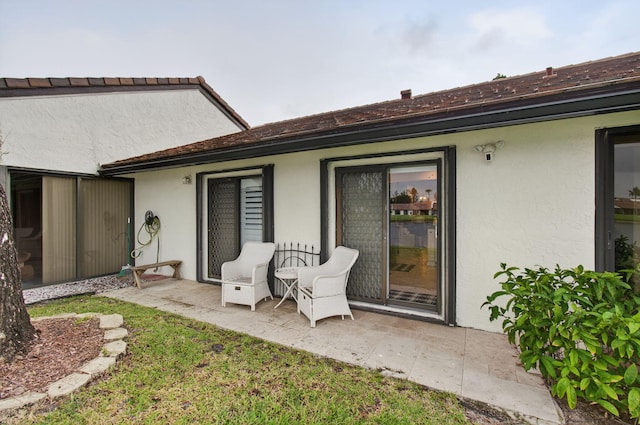 5707 Parkwalk Cir E, Boynton Beach, FL 33472 - rear view of house featuring stucco siding and a patio