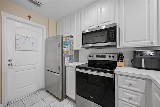 11 Live Oak Cir Unit 11, Tequesta, FL 33469 - kitchen featuring stainless steel appliances, light tile patterned floors, and white cabinets