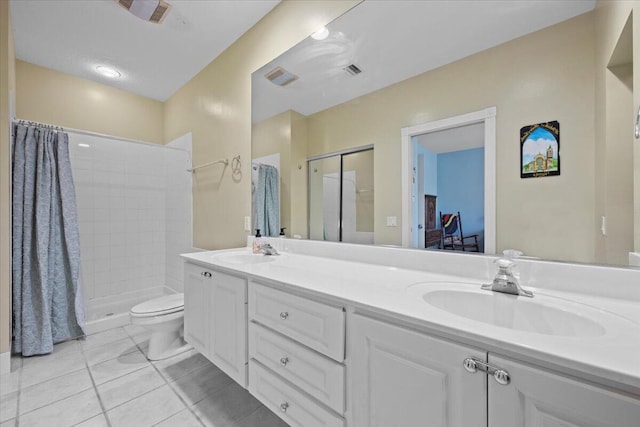 11 Live Oak Cir Unit 11, Tequesta, FL 33469 - bathroom with double vanity, tile patterned floors, and tiled shower